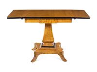 A Biedermeier Style Parcel Ebonized Satinwood Veneered Sofa Table