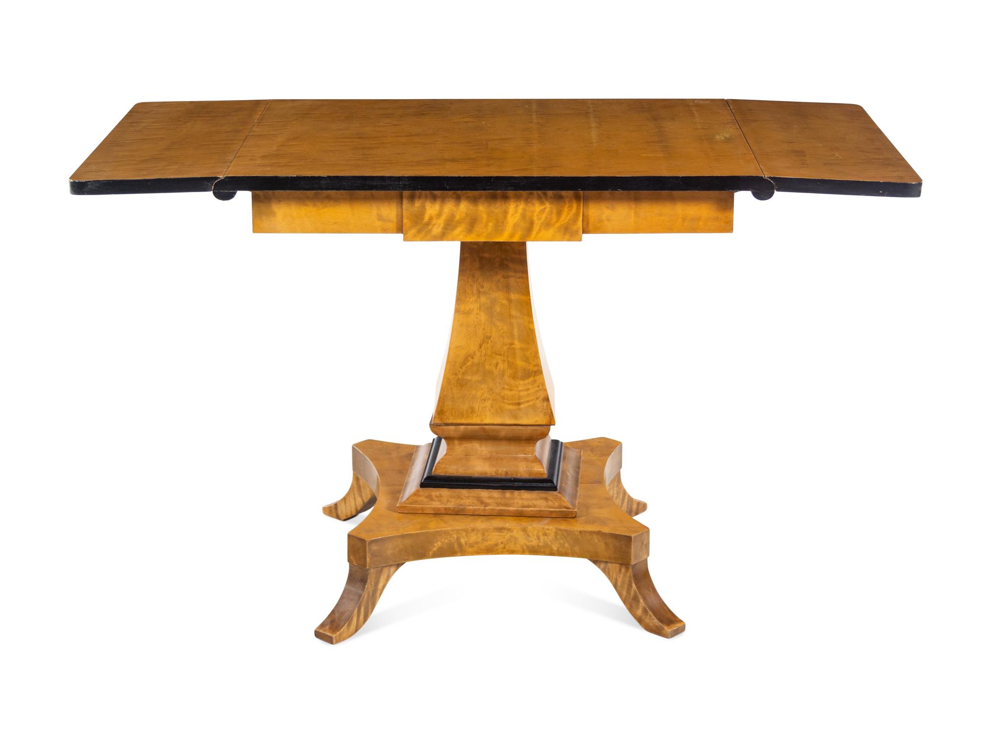 A Biedermeier Style Parcel Ebonized Satinwood Veneered Sofa Table