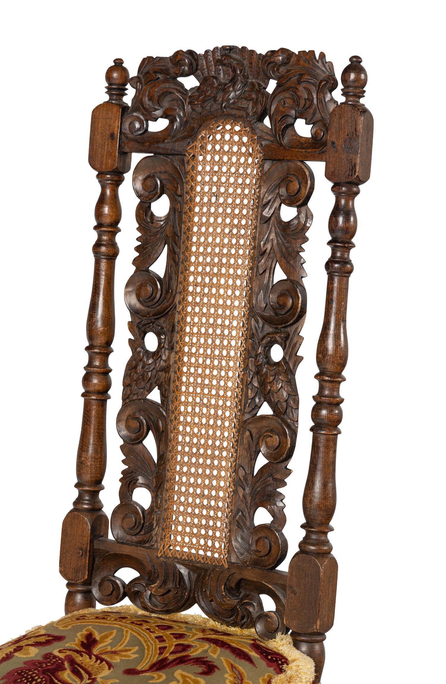 A Set of Four William and Mary Style Carved Oak Dining Chairs