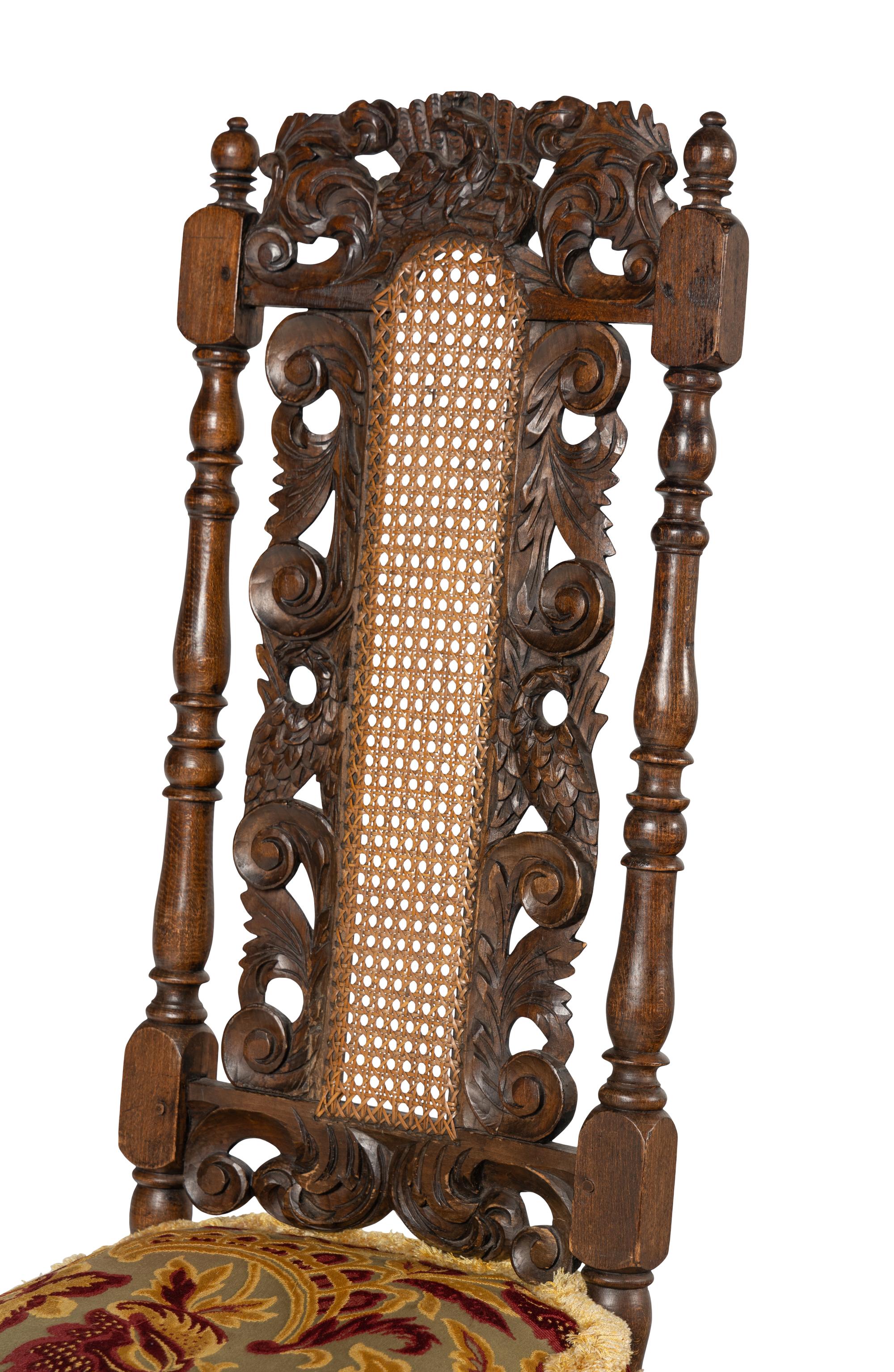 A Set of Four William and Mary Style Carved Oak Dining Chairs