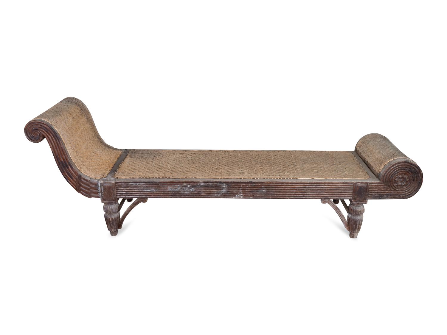 An Indonesian Carved Teak Chaise Longue — 20TH CENTURY