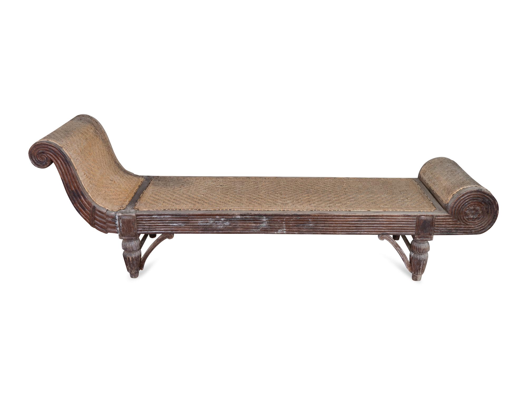 An Indonesian Carved Teak Chaise Longue — 20TH CENTURY