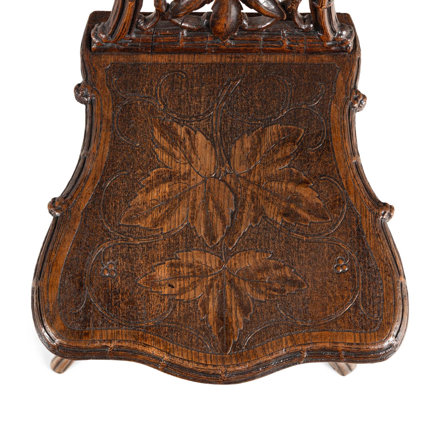 A Pair of Black Forest Oak Leaf Carved Side Chairs