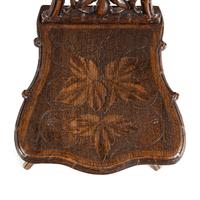 A Pair of Black Forest Oak Leaf Carved Side Chairs