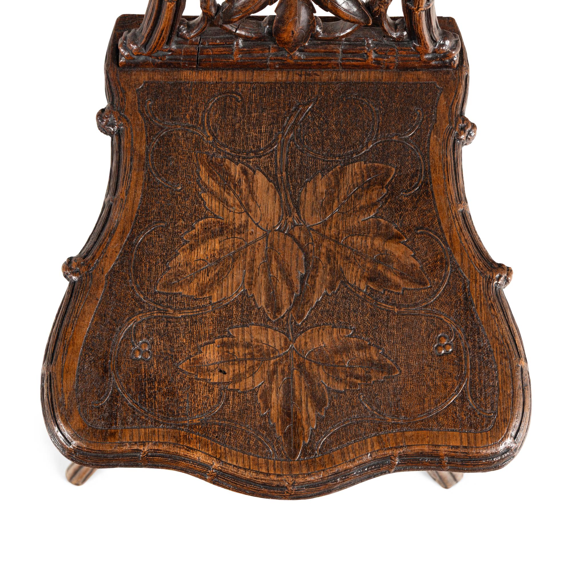 A Pair of Black Forest Oak Leaf Carved Side Chairs