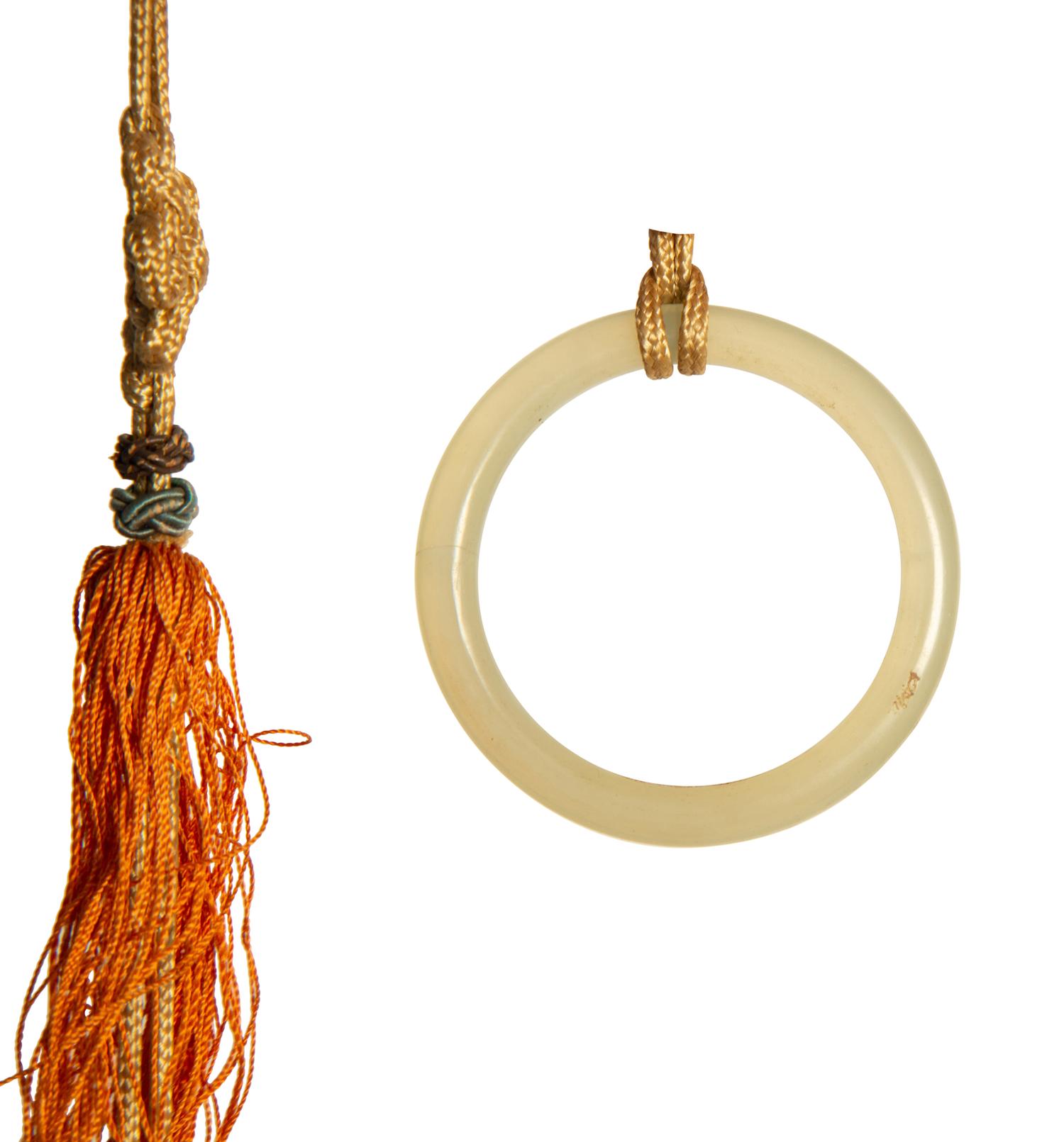 A Pair of Carved Jade Medallion and Tasseled Wall Hangings