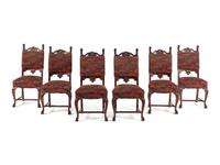 A Renaissance Revival Carved Mahogany Dining Table and Set of Six Chairs