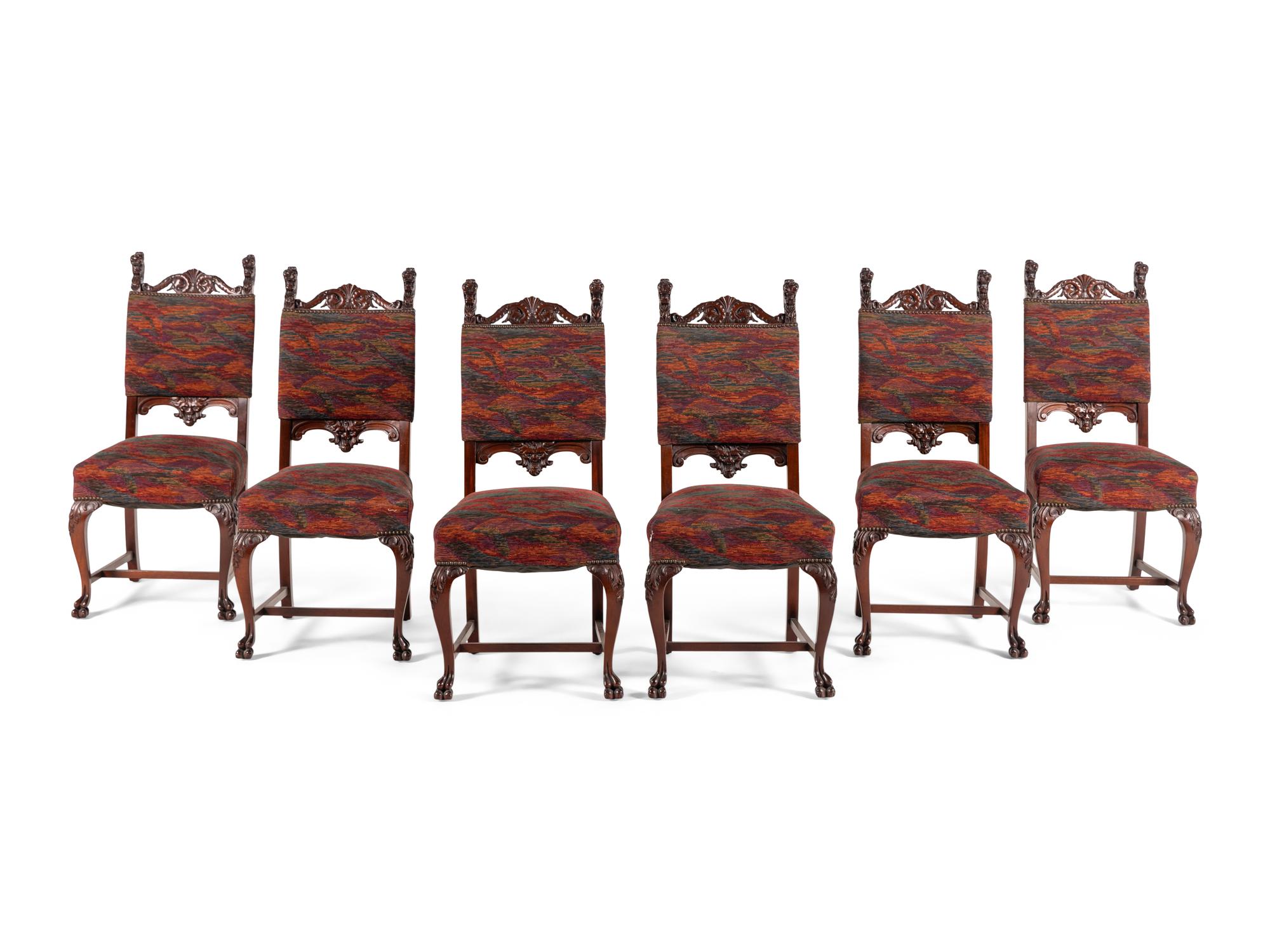 A Renaissance Revival Carved Mahogany Dining Table and Set of Six Chairs