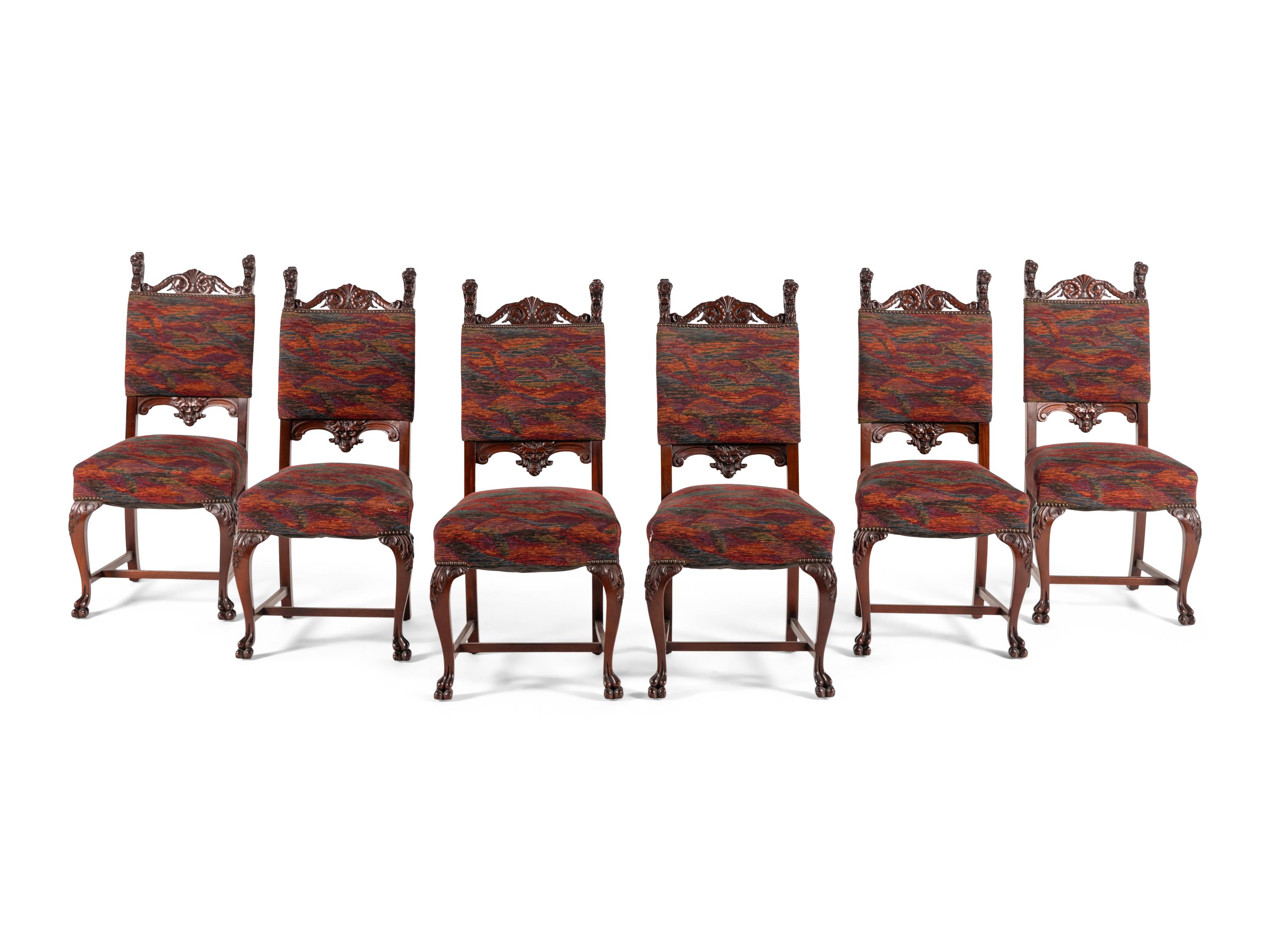A Renaissance Revival Carved Mahogany Dining Table and Set of Six Chairs