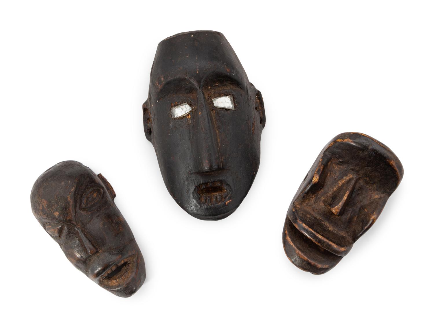 A Group of Eight Miniature Ethnographic Carved Masks