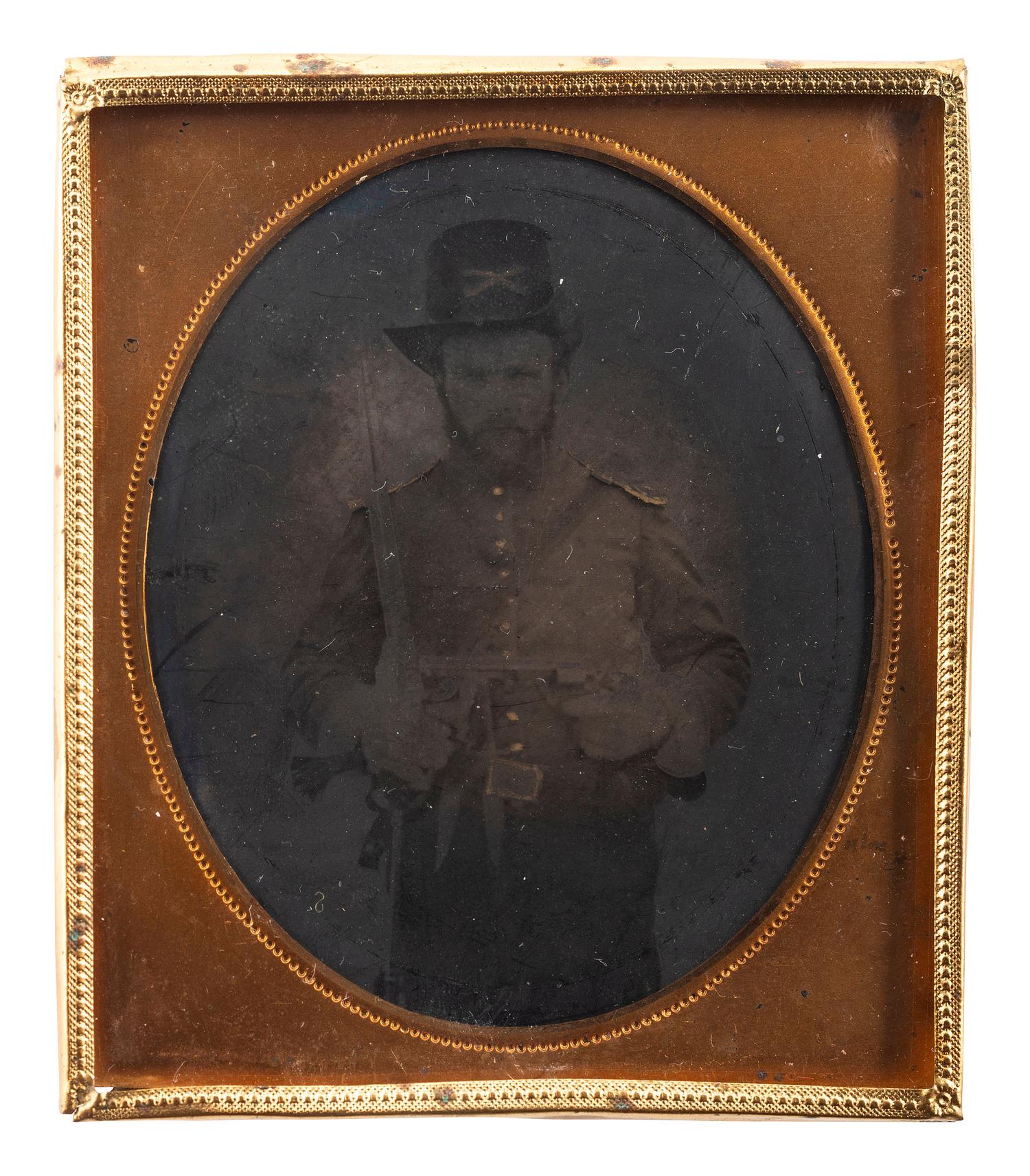 [CIVIL WAR]. Sixth plate tintype of Union cavalryman posed with multiple weapons.