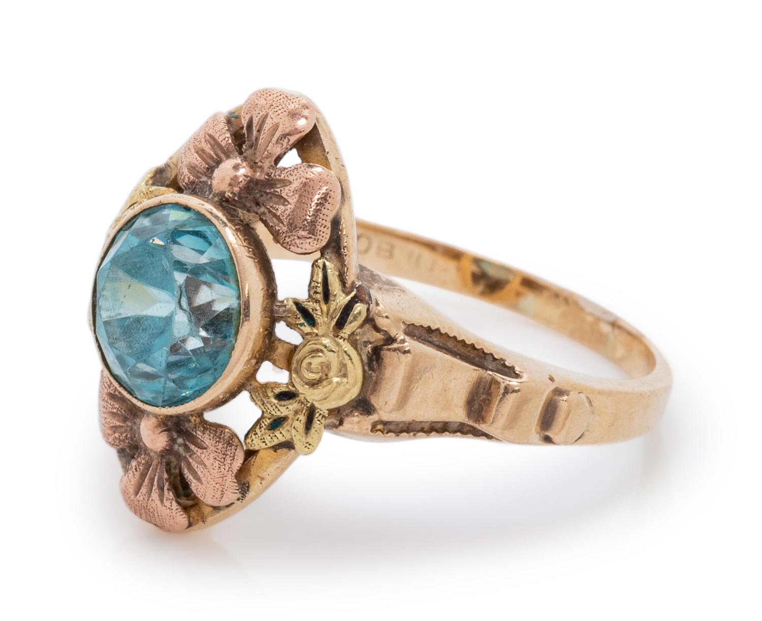 A 10 Karat Bicolor Gold and Blue Zircon Floral Motif Ring,