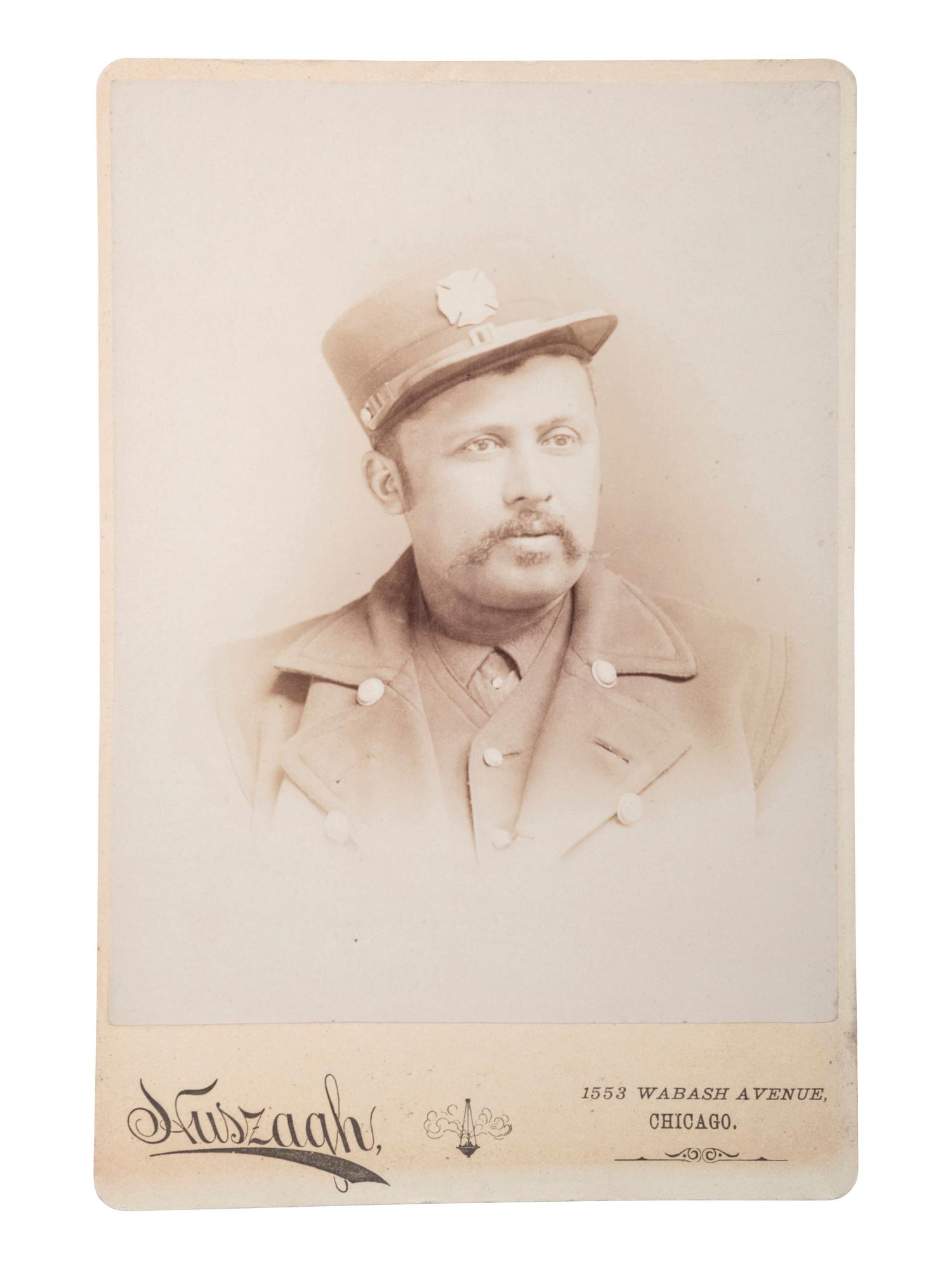 [EARLY PHOTOGRAPHY]. HUSZAGH, photographer. Cabinet card of African American firefighter. Chicago, IL, ca late 19th century.