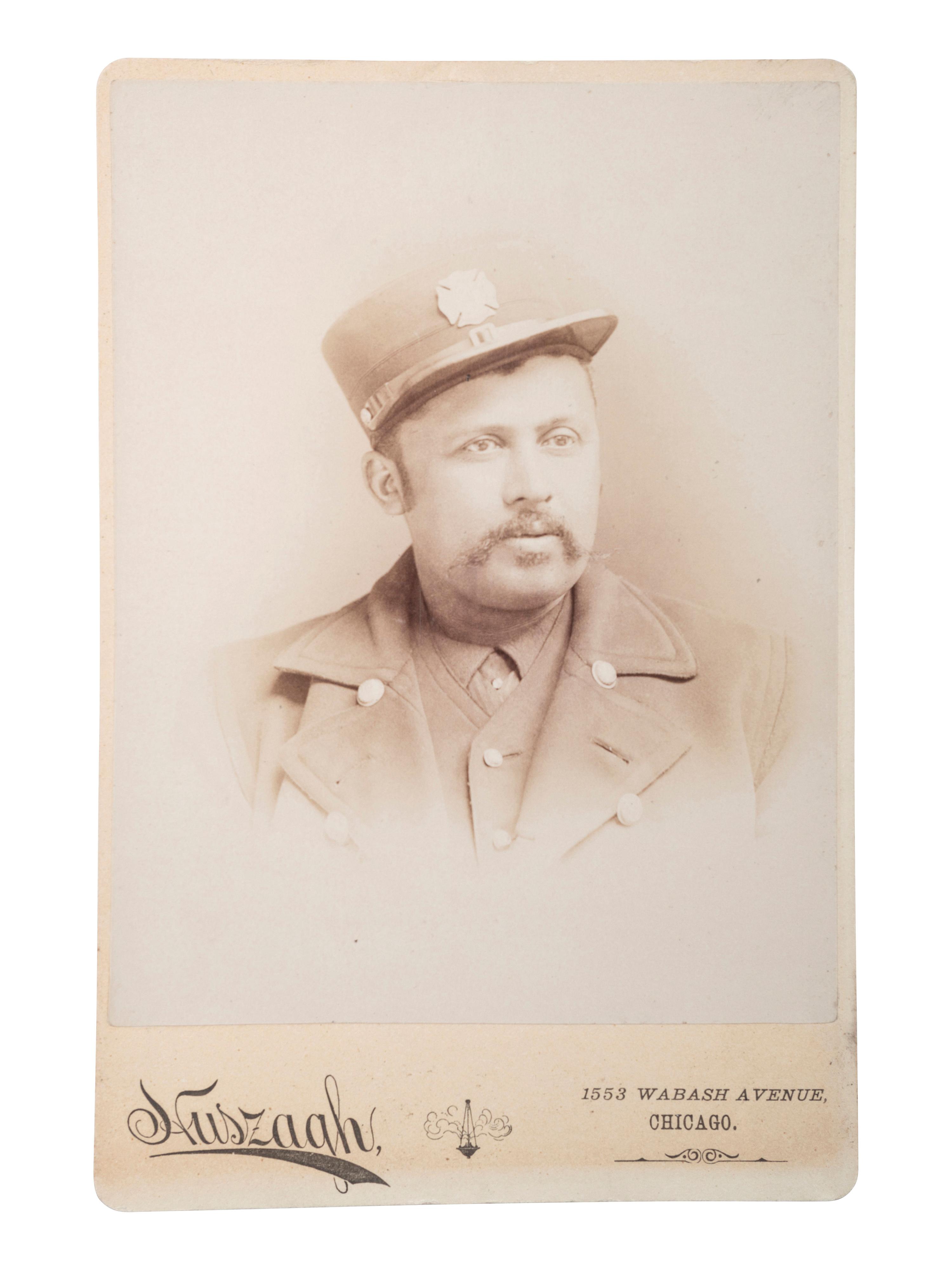[EARLY PHOTOGRAPHY]. HUSZAGH, photographer. Cabinet card of African American firefighter. Chicago, IL, ca late 19th century.
