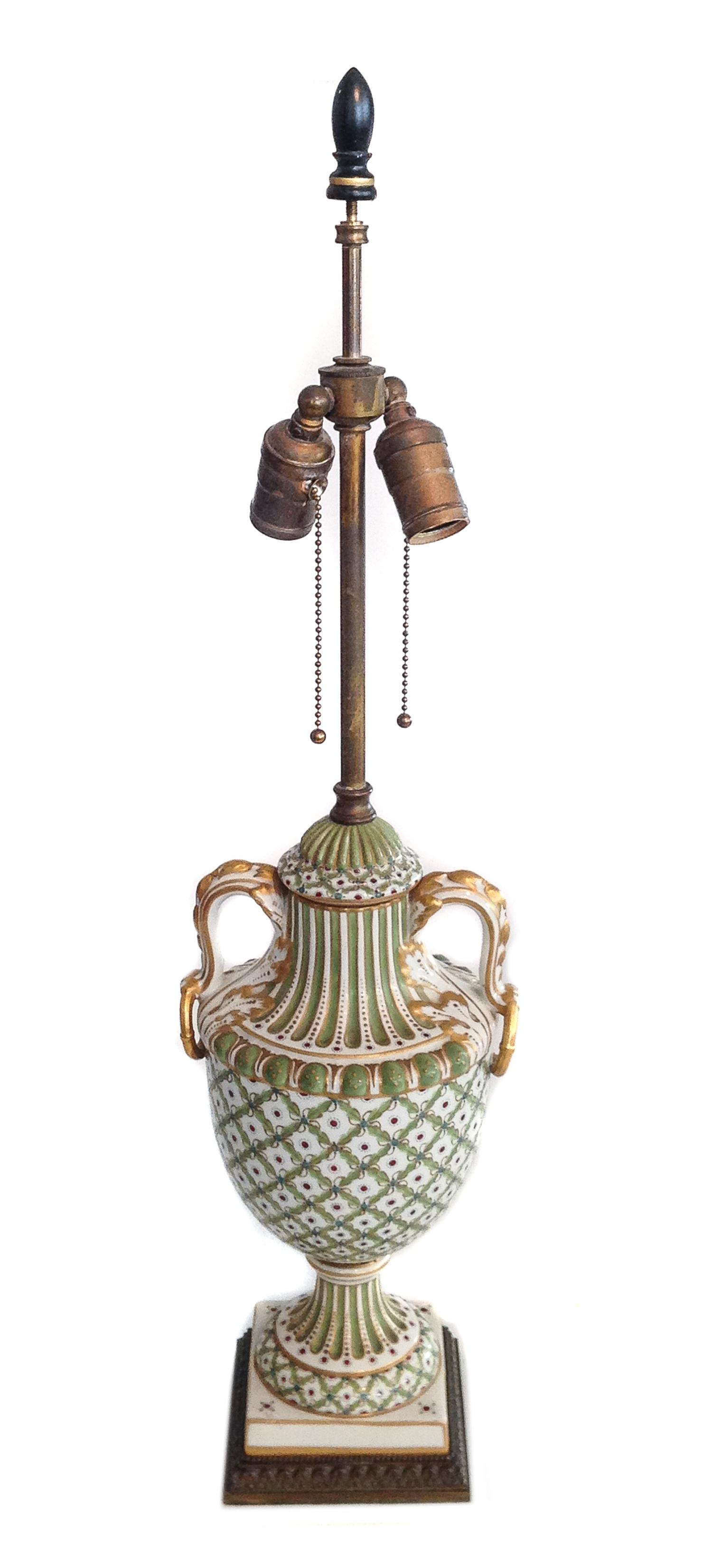 A Continental Porcelain Polychrome and Gilt Decorated Urn Height 27 inches.