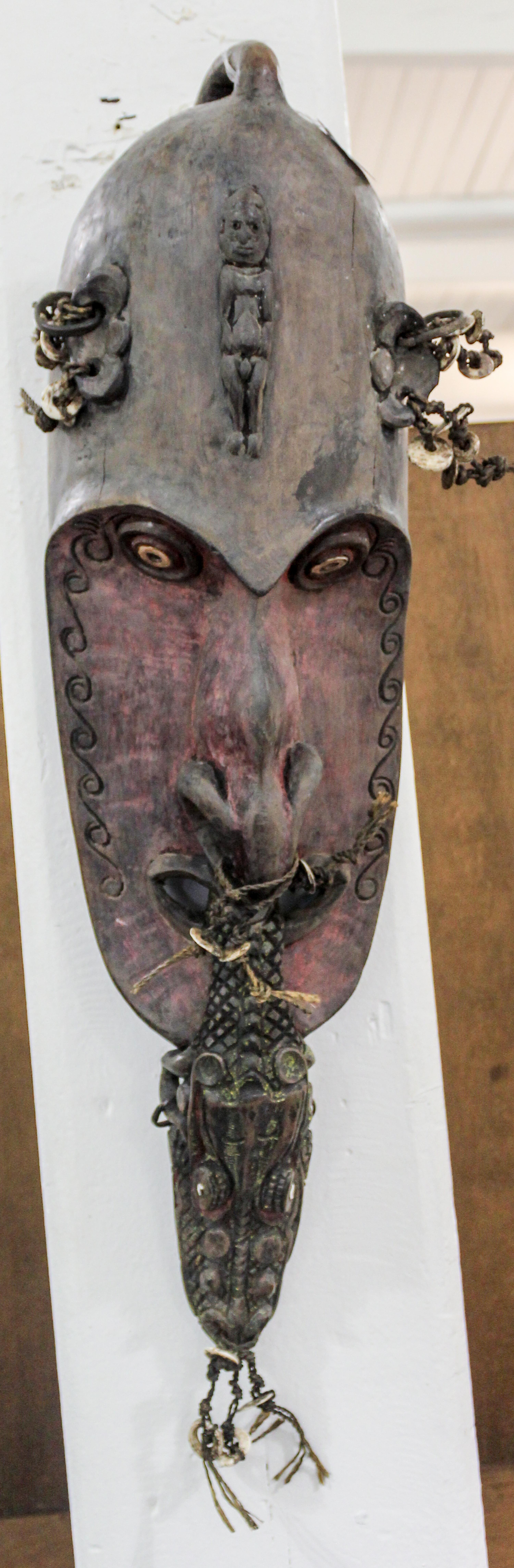 A Carved and Decorated Mask, Papua New Guinea Height 28 inches. — 20TH CENTURY