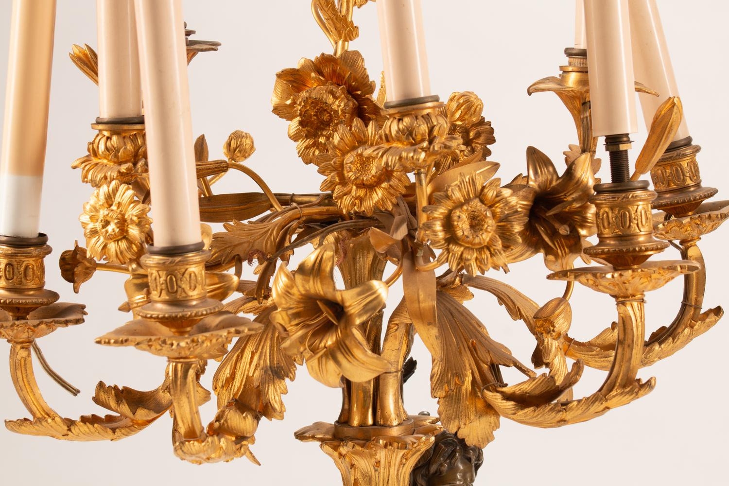 A Pair of Parcel-Gilt and Patinated Bronze Figural Eight-Light Candelabra — 19TH CENTURY