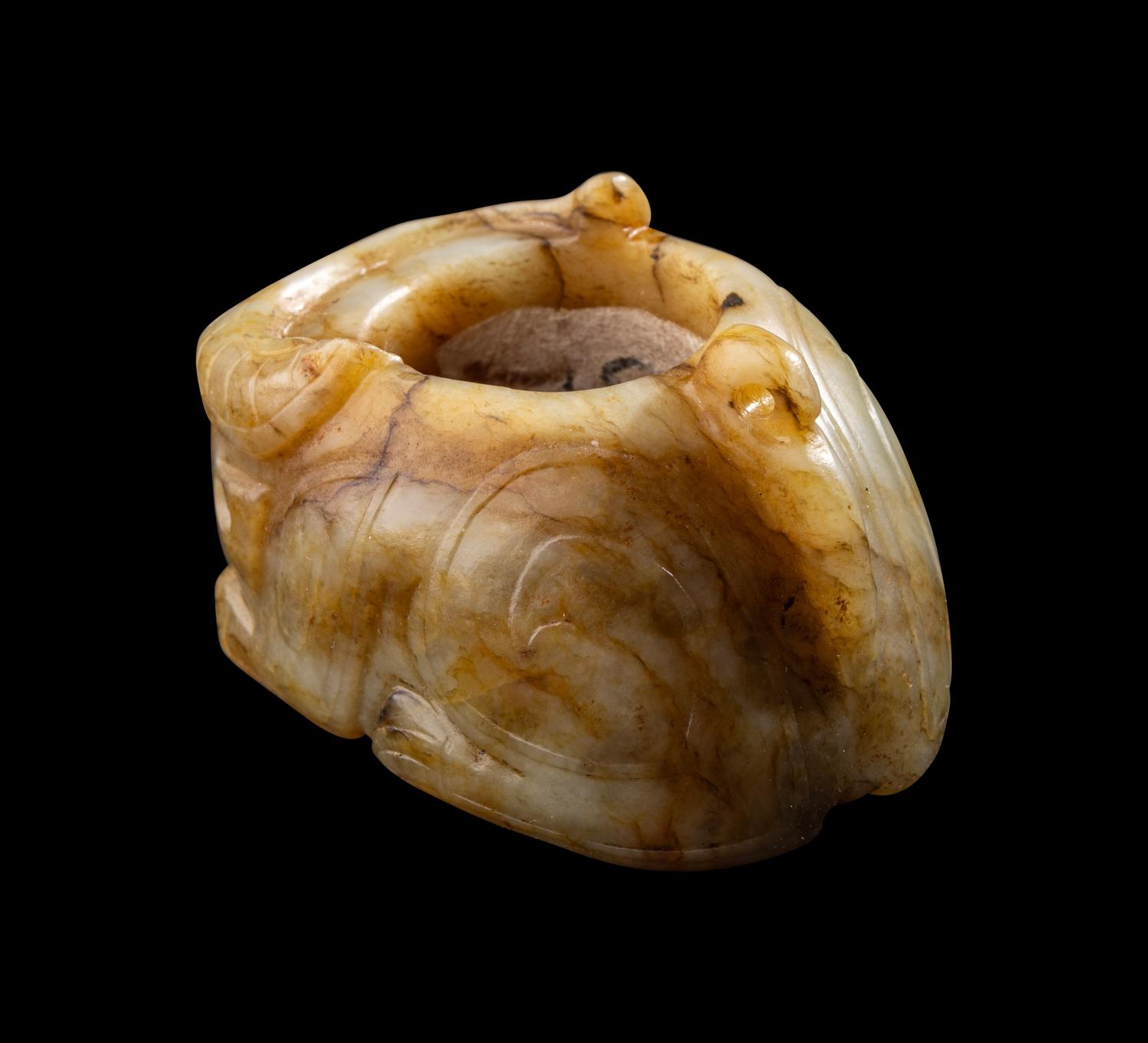 A Chinese Archaistic Yellow Jade Buffalo-Form Archer's Ring