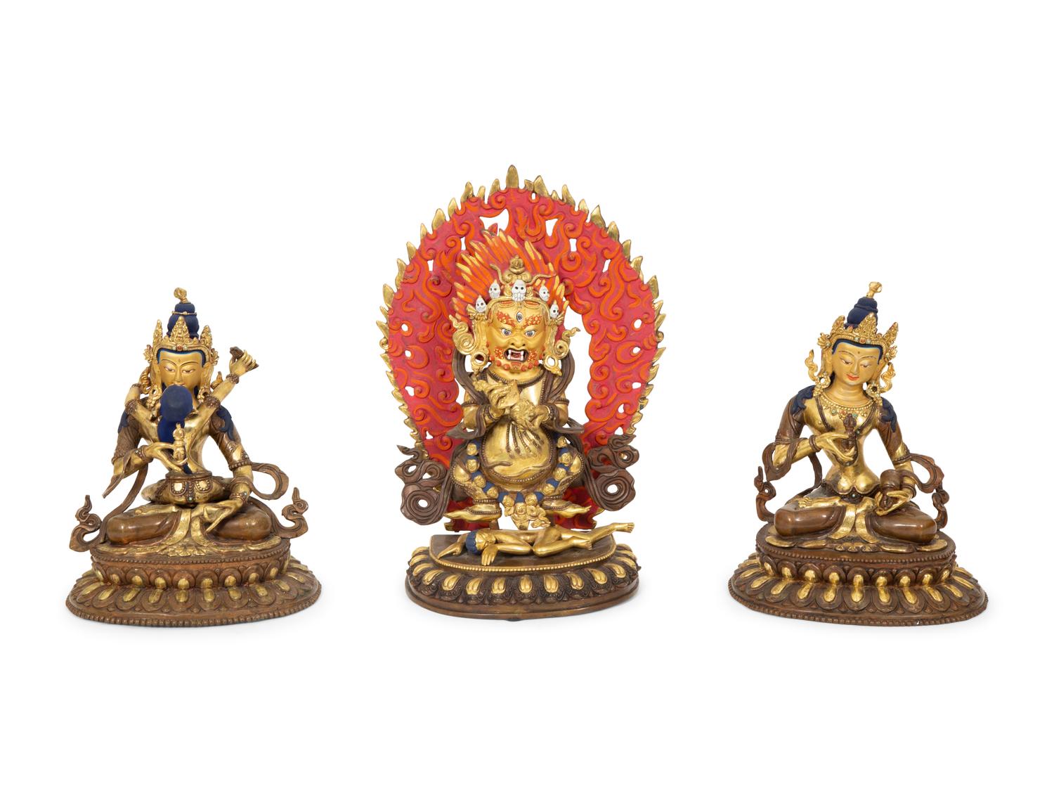 A Group of Three Tibetan Polychromed Brass Deities