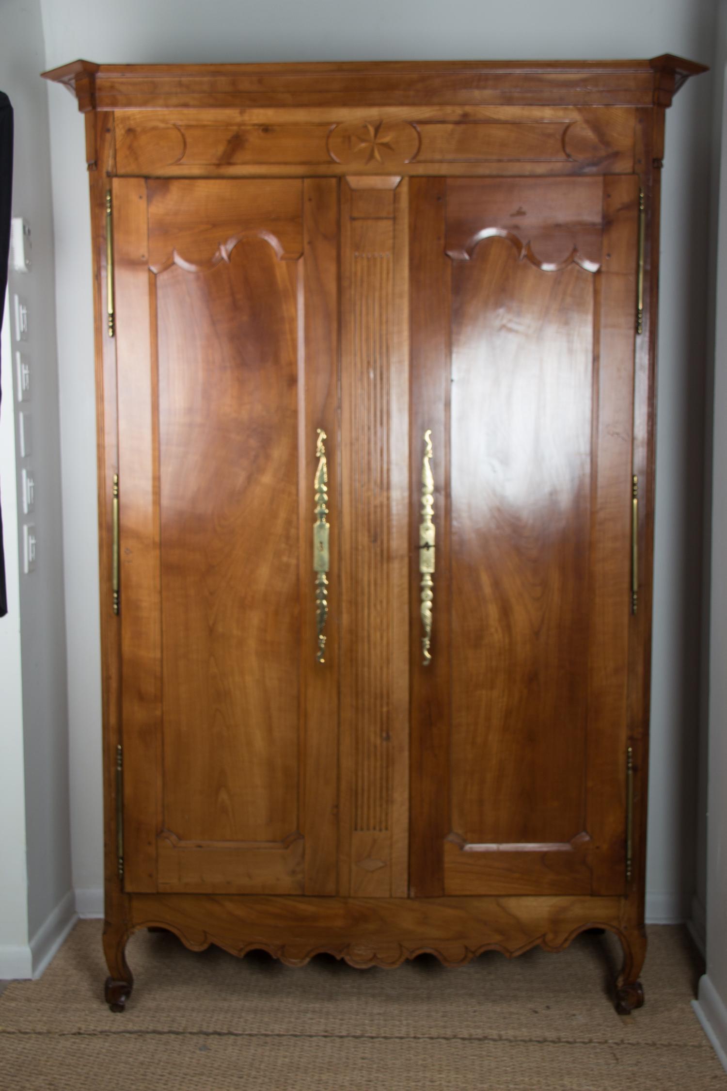 A French Provincial Style Walnut Armoire Height 88 x width 56 1/2 x depth 26 inches. — 20TH CENTURY