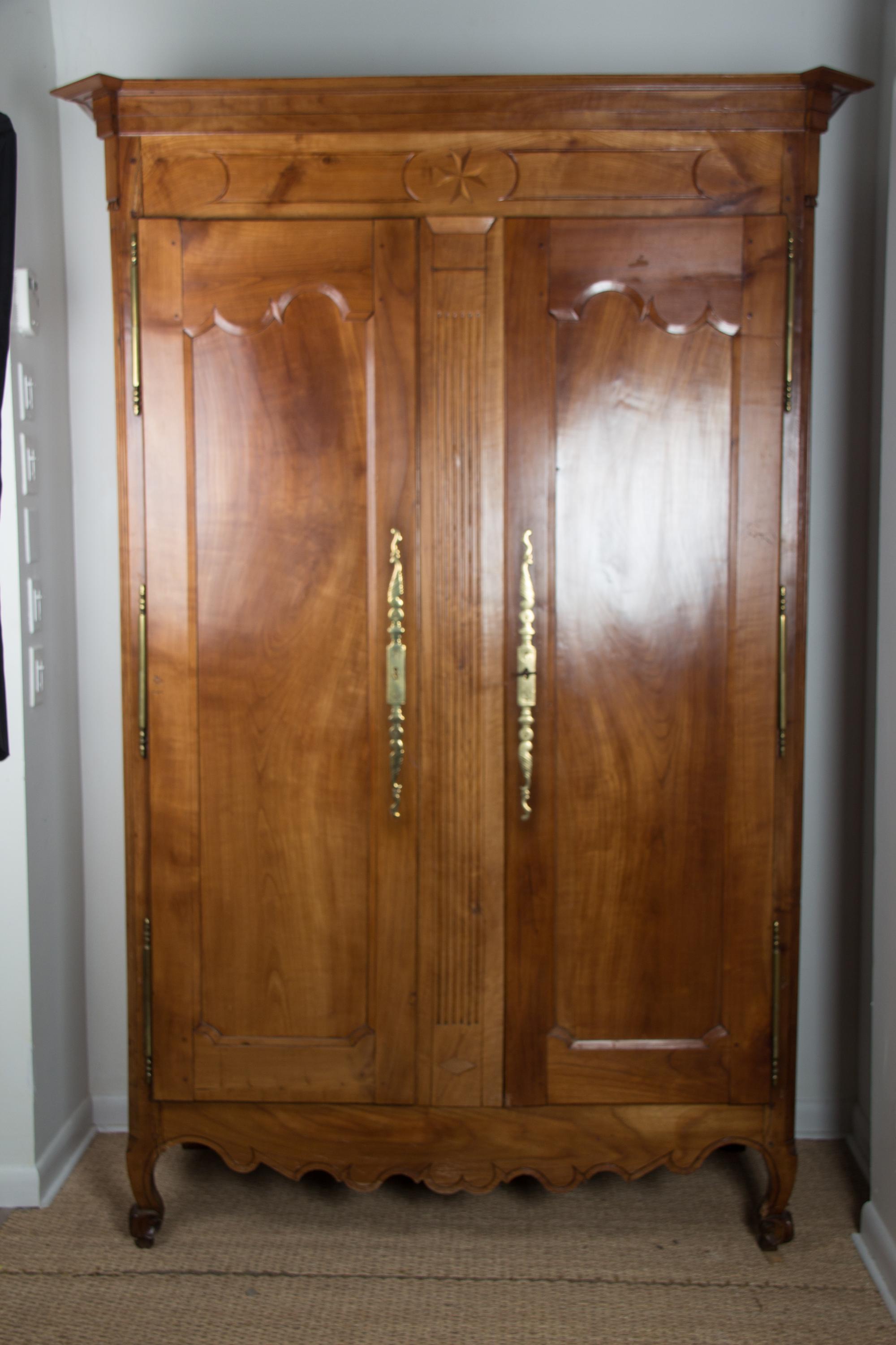 A French Provincial Style Walnut Armoire Height 88 x width 56 1/2 x depth 26 inches. — 20TH CENTURY