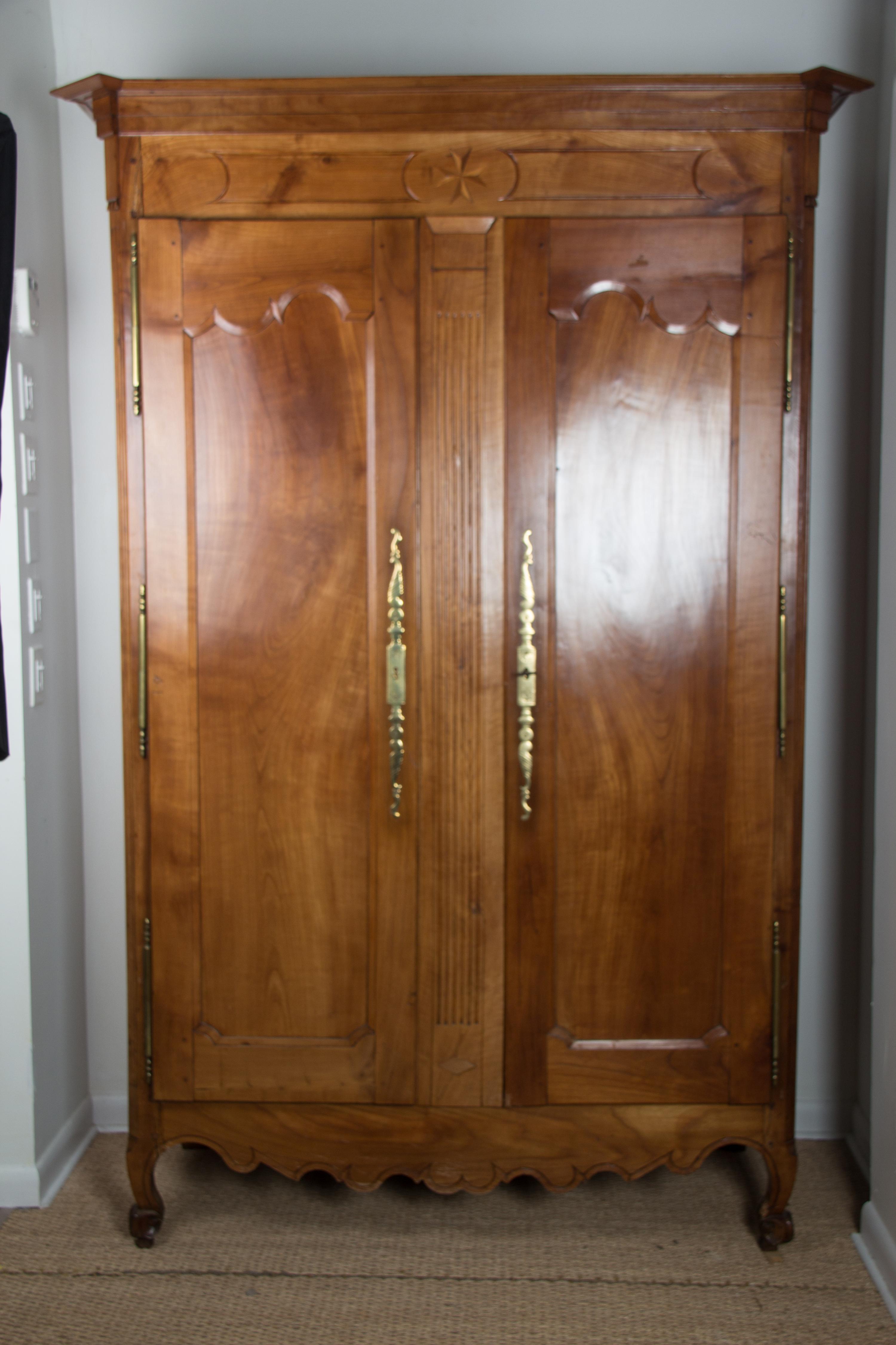 A French Provincial Style Walnut Armoire Height 88 x width 56 1/2 x depth 26 inches. — 20TH CENTURY