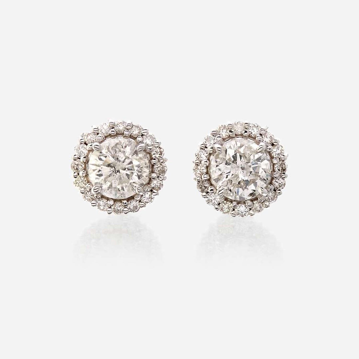 A pair of diamond and eighteen karat white gold earrings