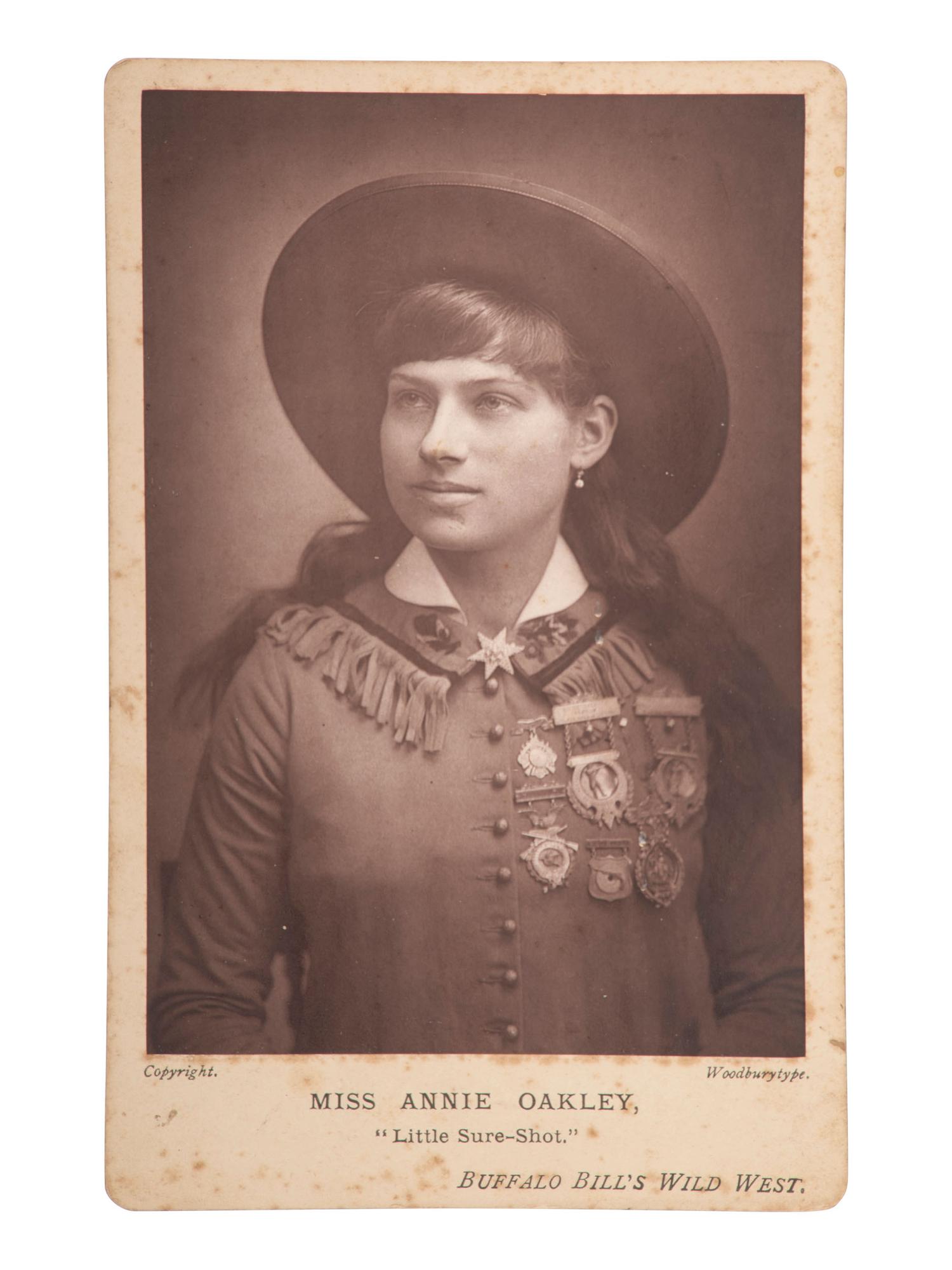 [WILD WEST SHOWS]. Miss Annie Oakley, "Little Miss Sure-Shot," Buffalo Bill's Wild West. Woodburytype cabinet card. [England: ca 1890s].