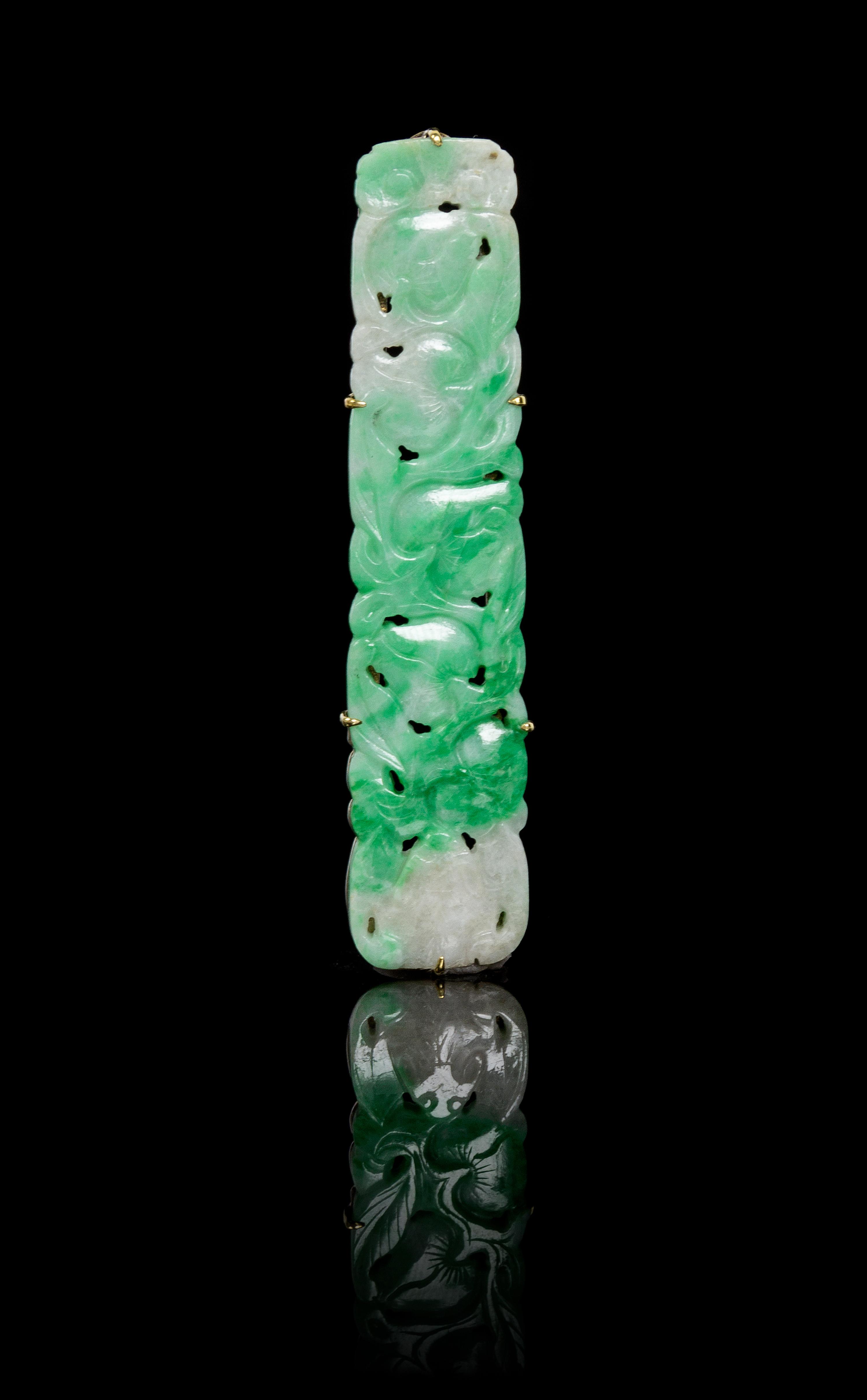 A Carved Jadeite Pendant Length 2 7/8 inches.