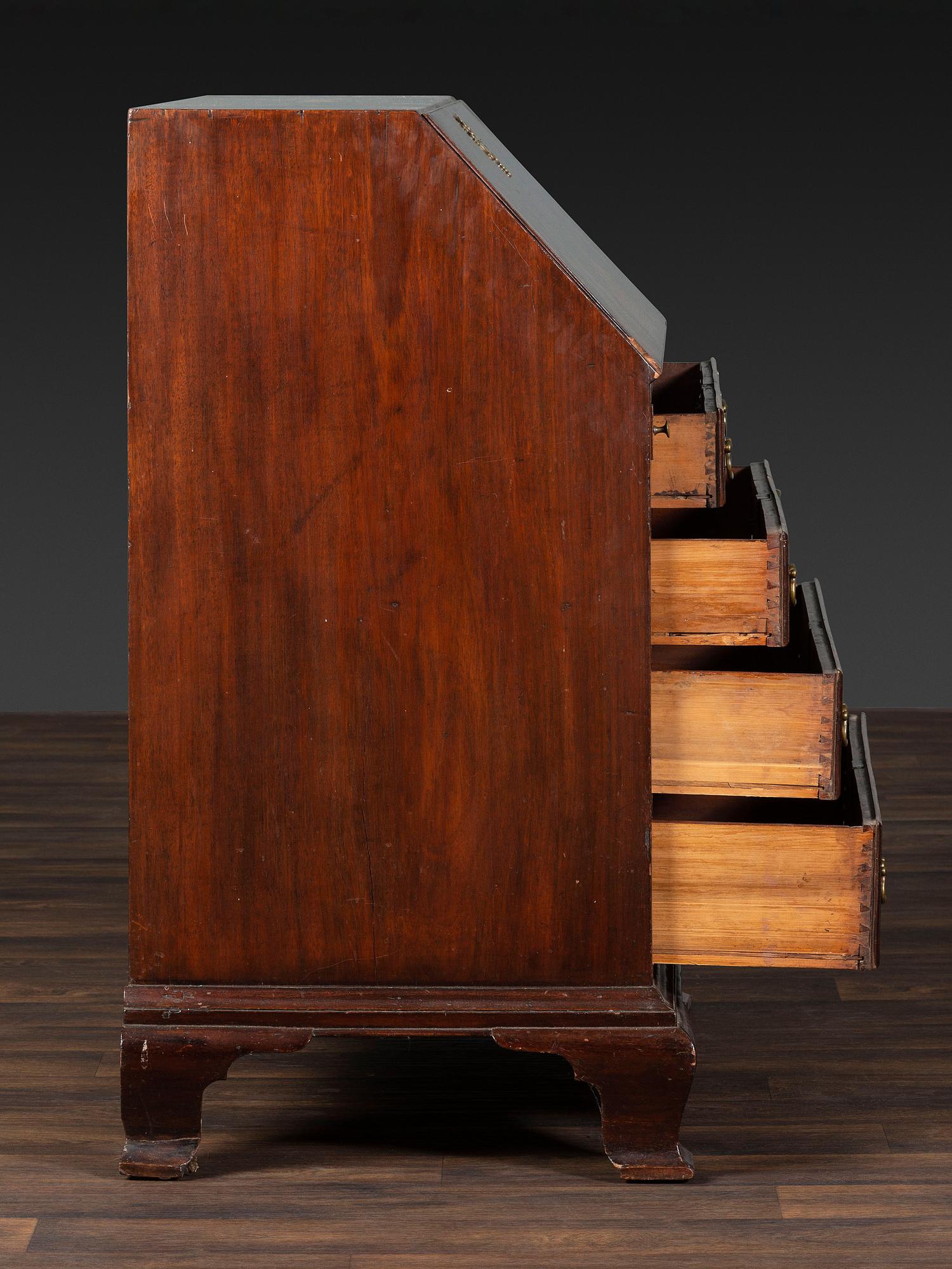 A Chippendale Figured and Shell-Carved Mahogany Slant Front Desk
