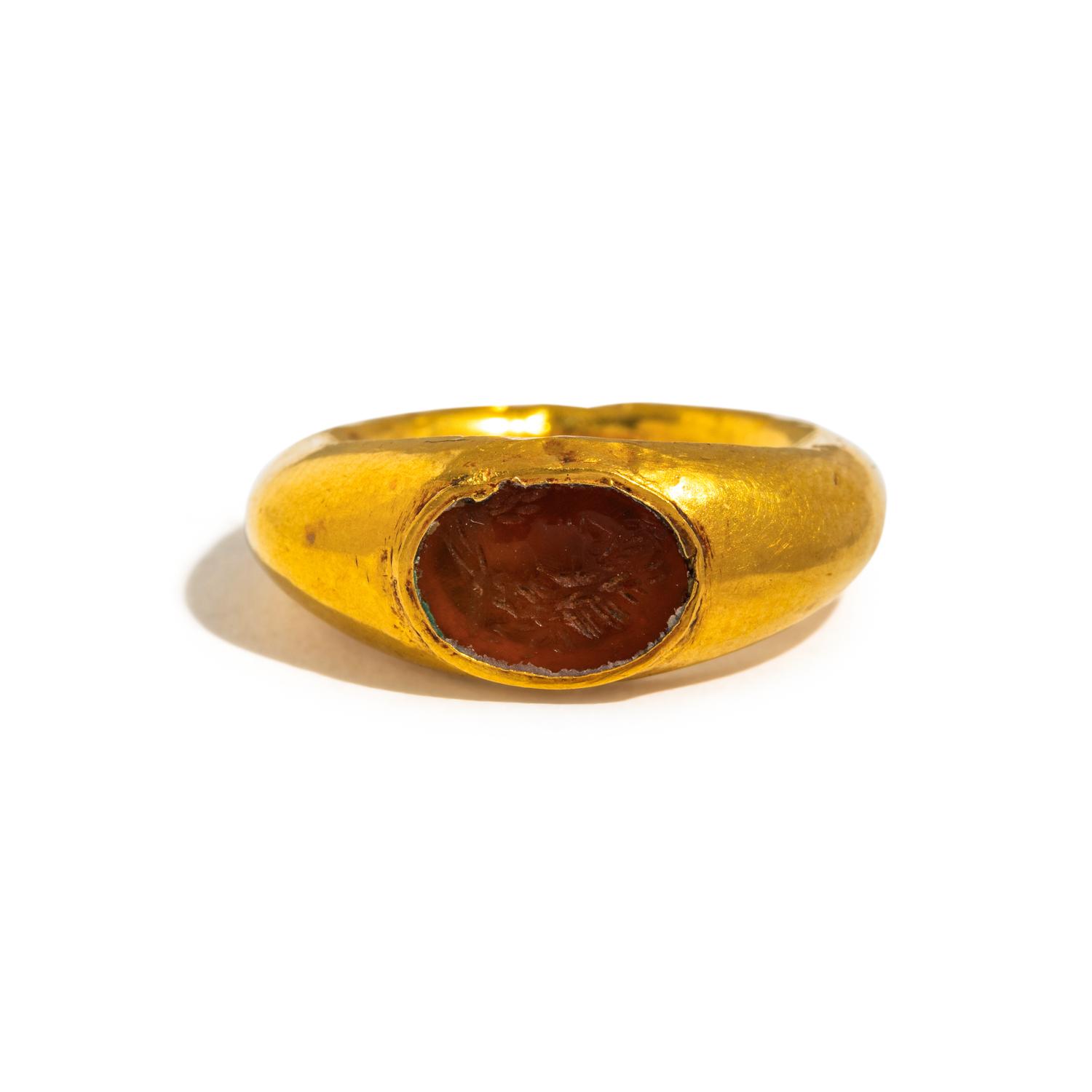A Roman Gold and Carnelian Finger Ring with a Male Portrait Head