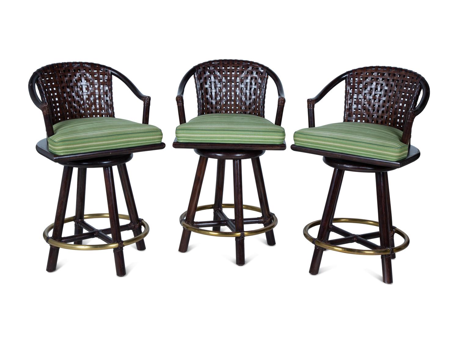 A Set of Three Stained Wood, Leather and Brass Bar Stools — 20TH CENTURY