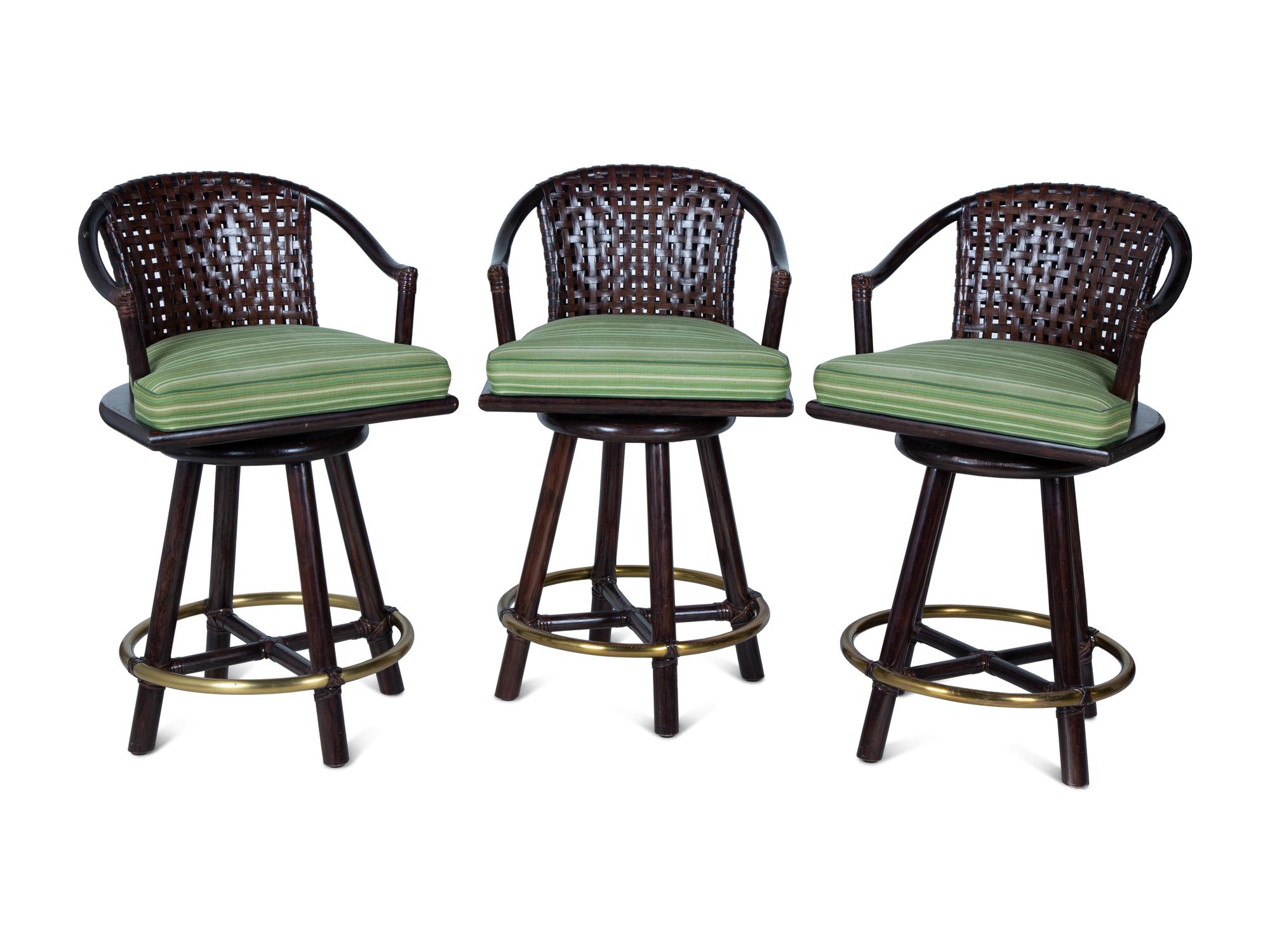 A Set of Three Stained Wood, Leather and Brass Bar Stools — 20TH CENTURY