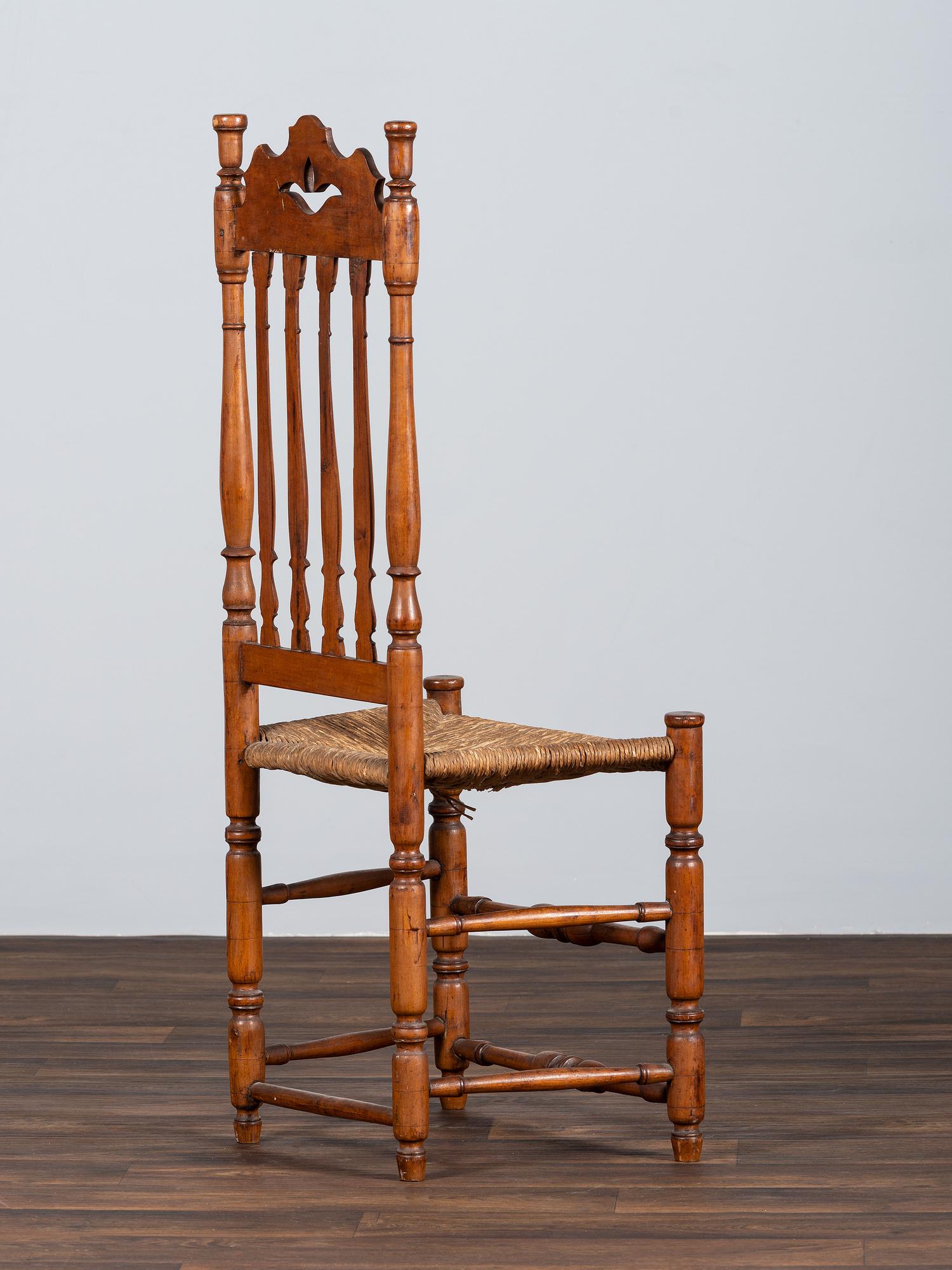 A William and Mary Style Turned and Pierced Carved Banister-Back Rush Seat Side Chair