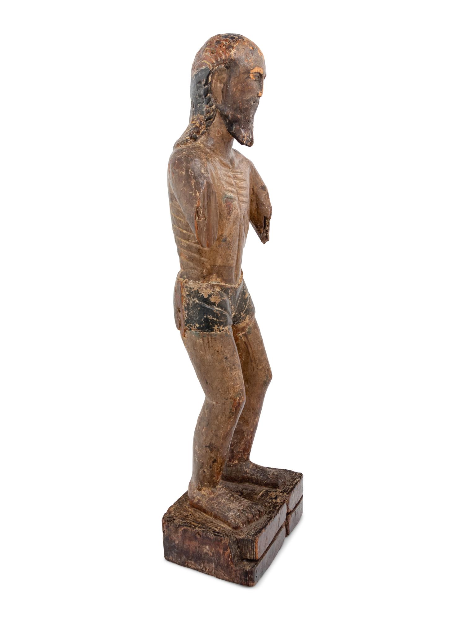 A Colonial Carved and Polychromed Figure of Christ