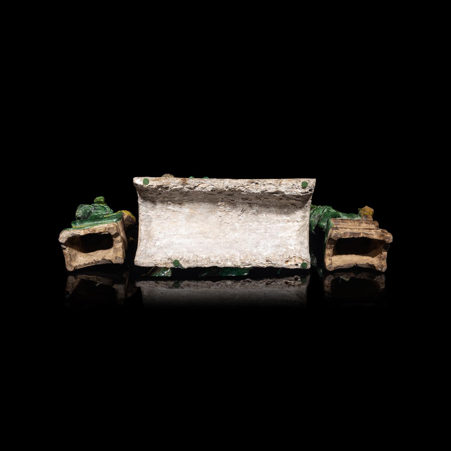 A Chinese Sancai Glazed ' Lion' Roof Tile and a Pair of Figures of Lions, Ming Dynasty 明 素三彩佛獅瓦當及佛獅像一對