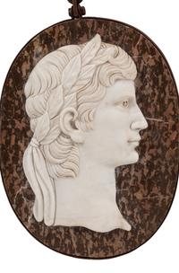 A Set of Four Italian Neoclassical Style Iron Mounted Marble Portrait Medallions