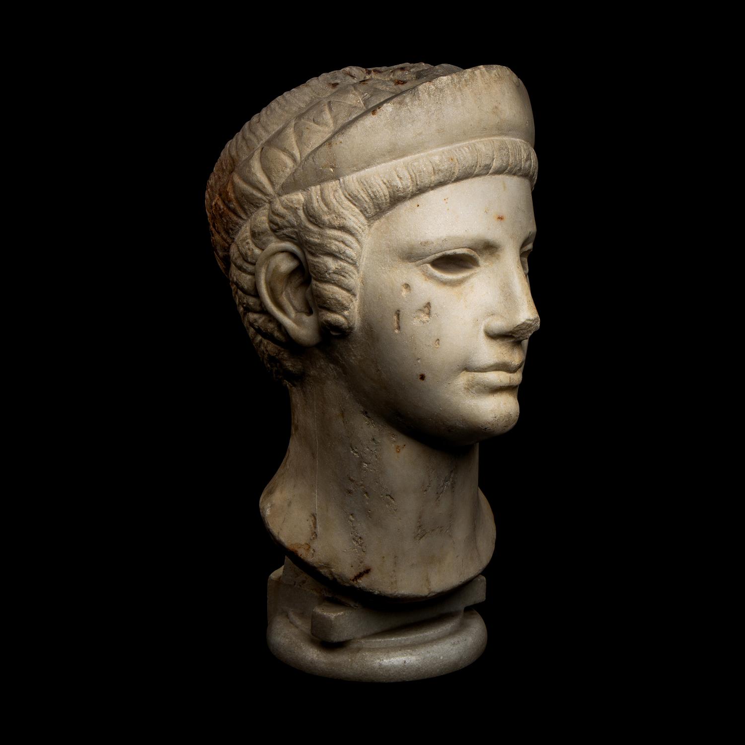 A Roman Marble Archaistic Head of a Goddess
