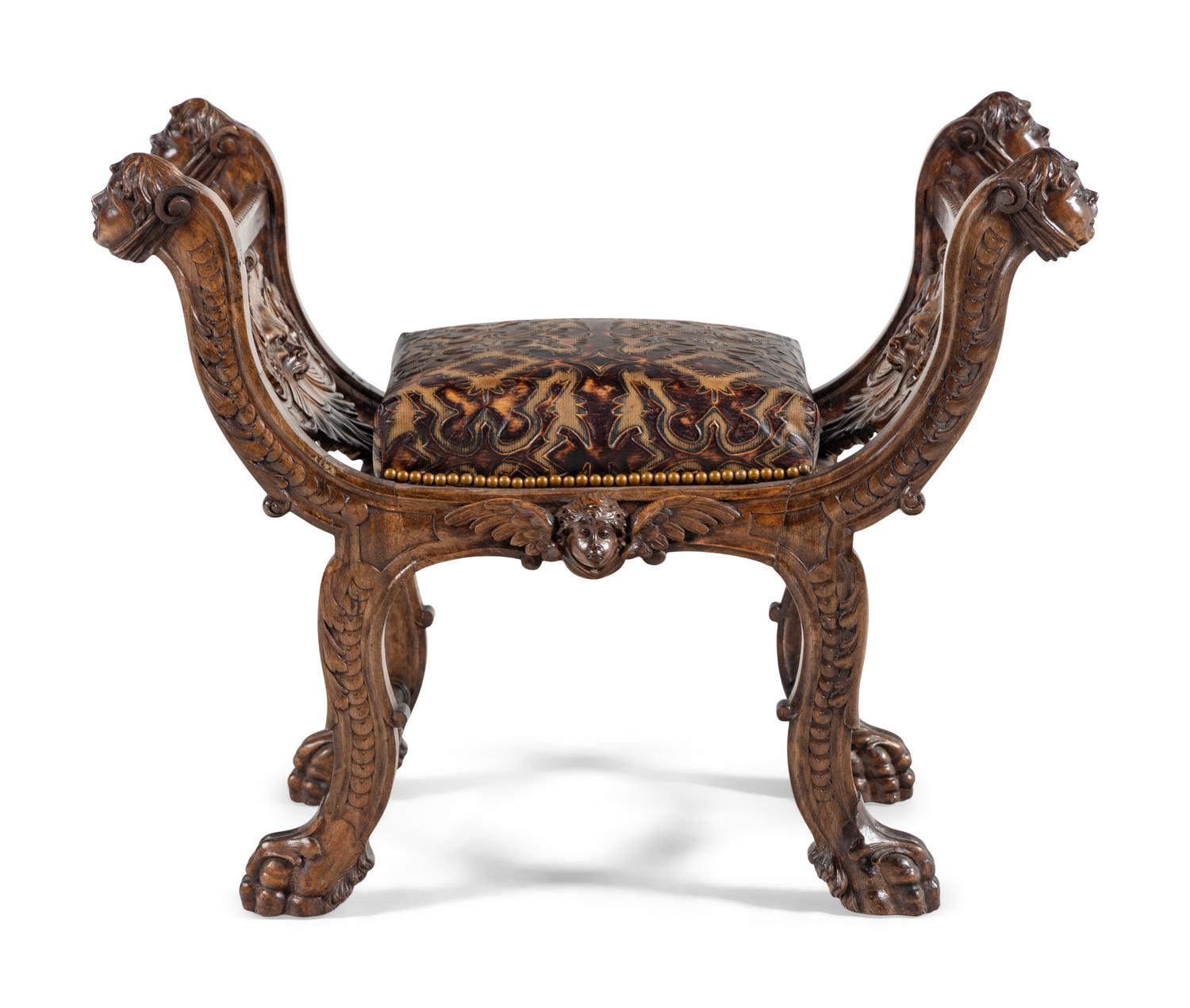 An Italian Renaissance Revival Carved Walnut Curule Bench