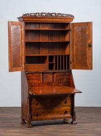 A Classical Style Carved and Highly Figured Tiger Maple Slant Front Desk