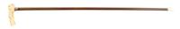 An American Sterling Silver, Carved Ivory and Cherry Cane, Height overall 36, width of handle 4 3/4 inches.