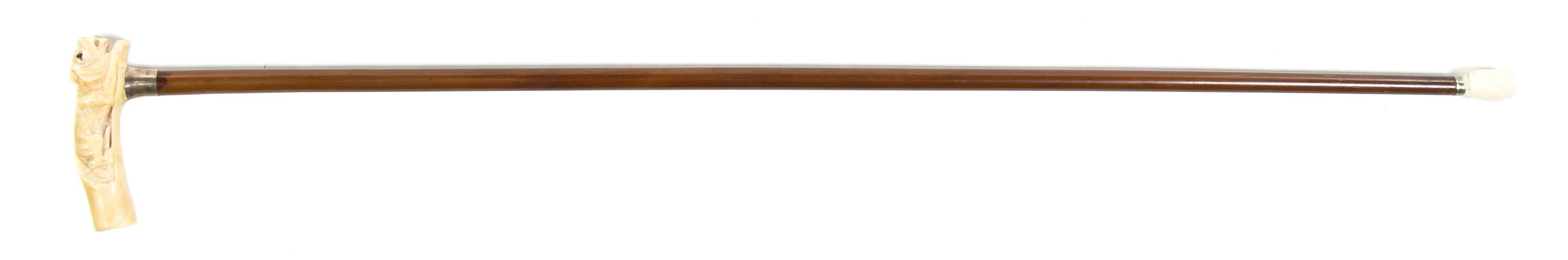 An American Sterling Silver, Carved Ivory and Cherry Cane, Height overall 36, width of handle 4 3/4 inches.