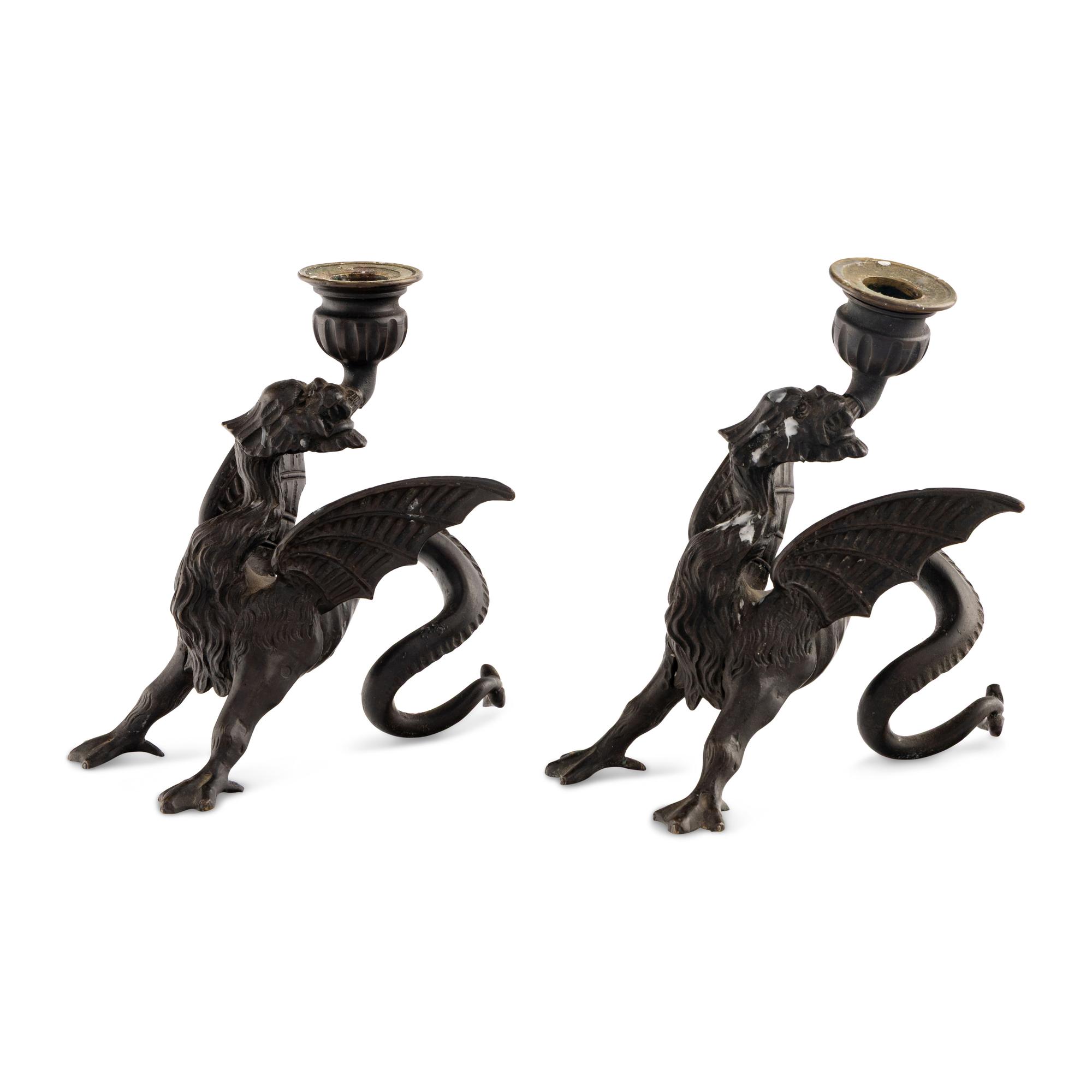 A Pair of Cast Metal Griffin Candlesticks