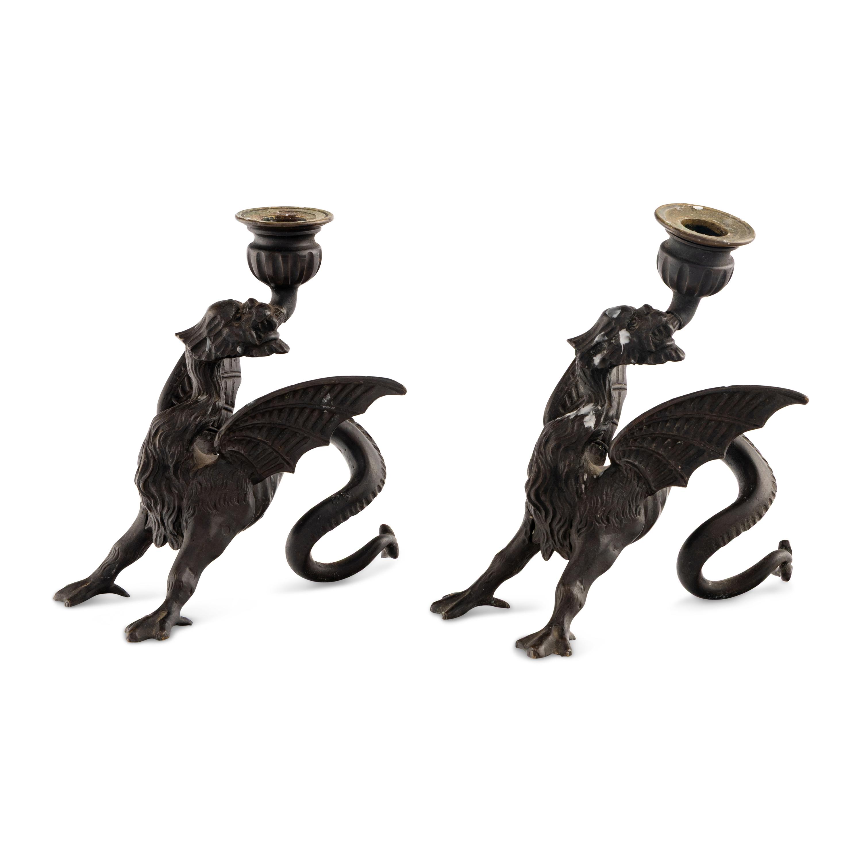A Pair of Cast Metal Griffin Candlesticks