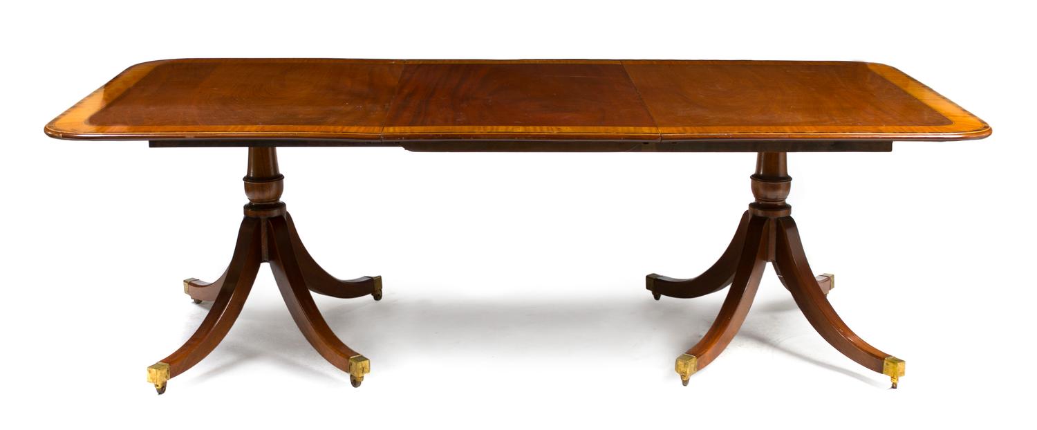 A George III Style Mahogany Double Pedestal Dining Table, Height 27 1/2 x width 63 x depth 45 inches (closed).