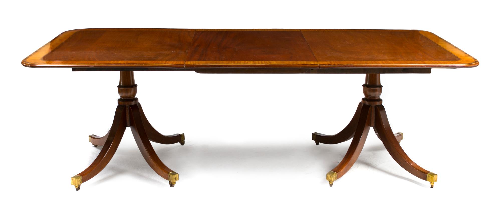 A George III Style Mahogany Double Pedestal Dining Table, Height 27 1/2 x width 63 x depth 45 inches (closed).