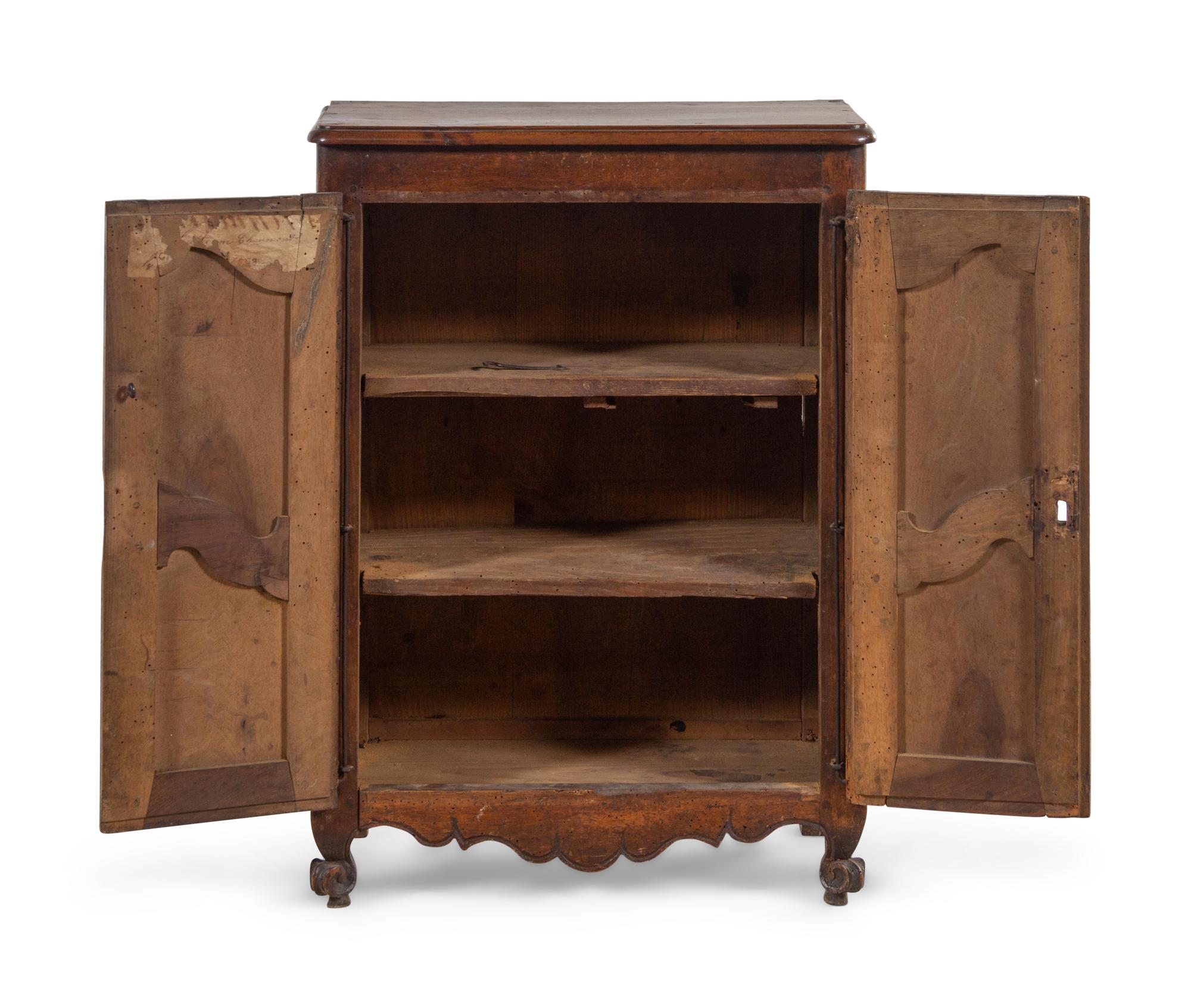 A French Provincial Carved Walnut Diminutive Armoire