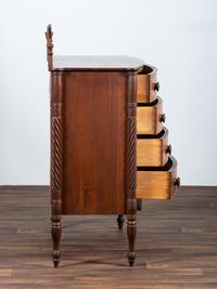 A Late Federal Spiral-Twist Carved and Figured Mahogany Chest of Drawers
