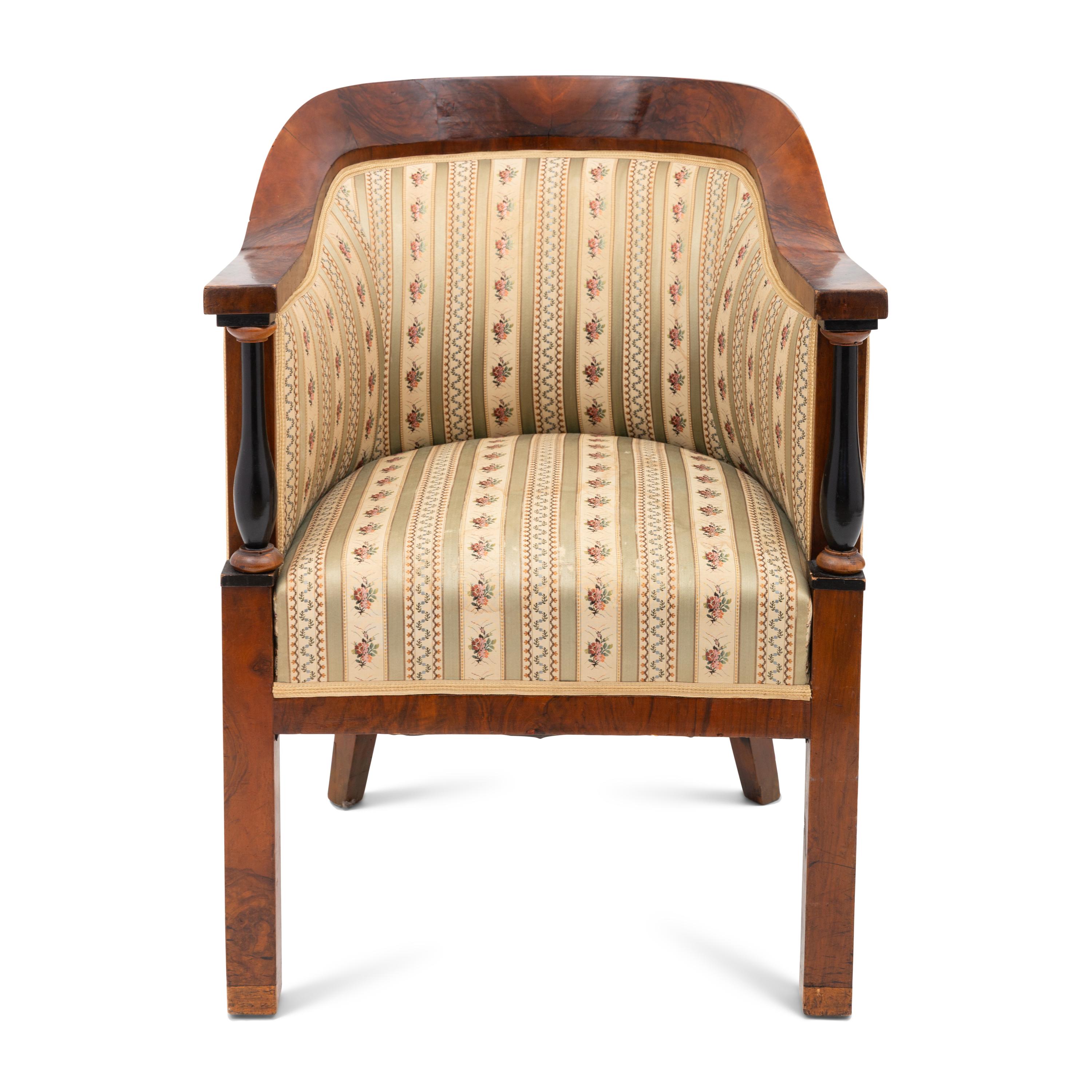 A Biedermeier Walnut and Ebonized Bergere