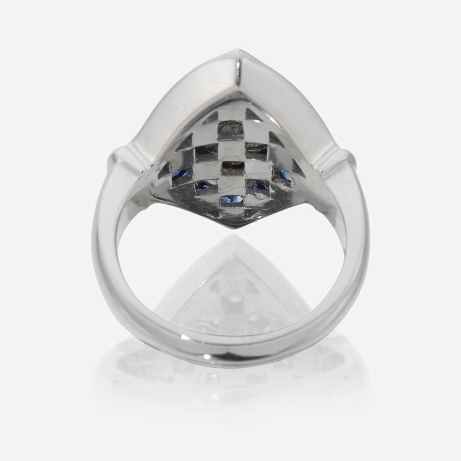 An eighteen karat white gold, diamond, and sapphire ring
